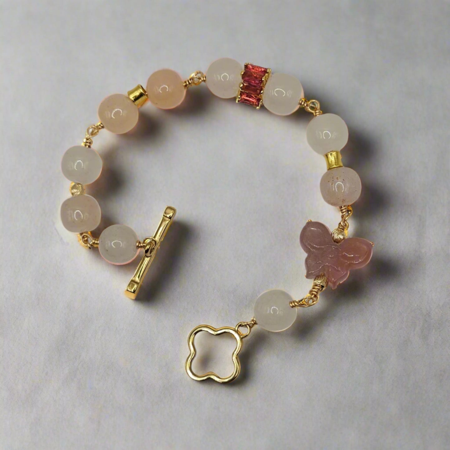 Bracelet with beads and gold accents on a gray background