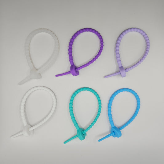 Set of colorful silicone bands on a light gray background