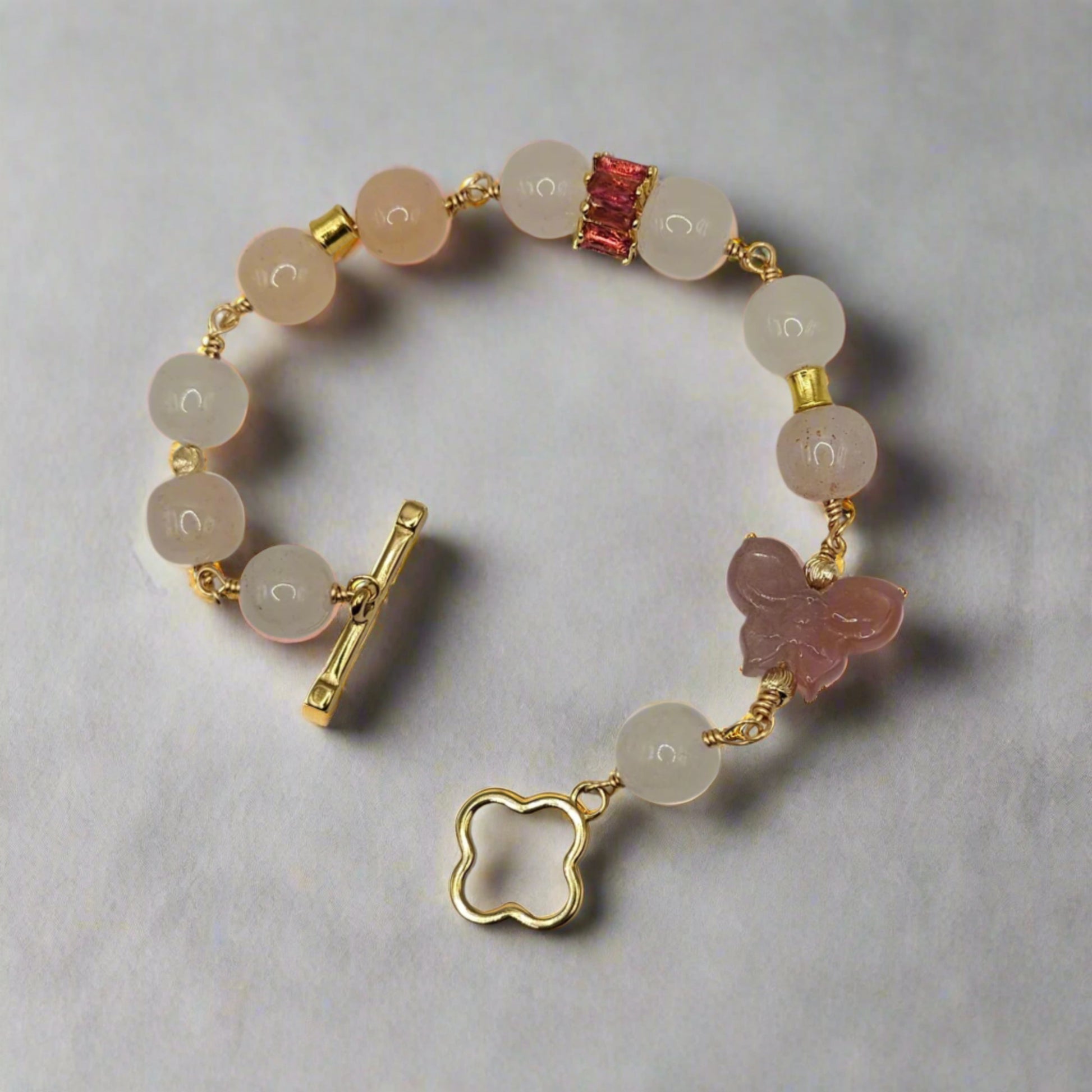 Bracelet with beads and gold accents on a gray background